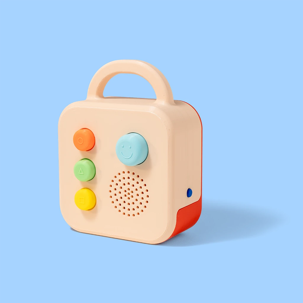 A Koobiba audio player, cream with a coral back and three coloured buttons