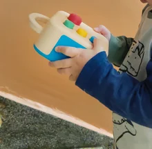 Child carrying Koobiba outdoors